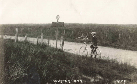 Old real photo postcard of a gentleman with his bicycle at Carter Bar