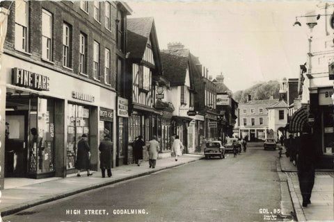 Old real photo postcard of High Street, Godalming in Surrey