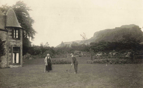 Old real photo postcard of gentleman on putting green