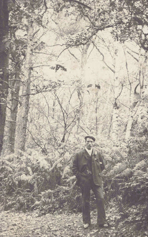 Old real photo postcard of man in woods, Wirral?