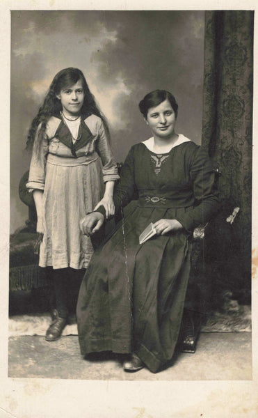 Old real photo postcard of a lady and girl, possibly her daughter