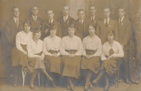 Old real photo postcard showing men and women - could be Liverpool